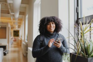 woman smiling and holding phone